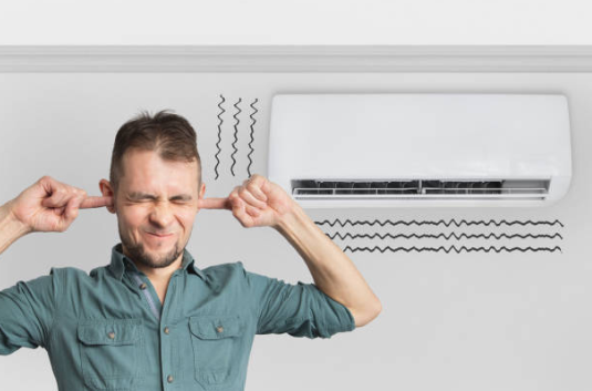 Homeowner covering their ears due to a ticking noise coming from the air conditioner in the background, indicating a potential AC issue that may need professional repair.