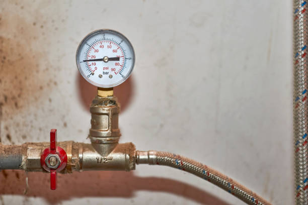 A pressure gauge installed on a plumbing or HVAC water line measuring system pressure during maintenance, troubleshooting, or performance testing.